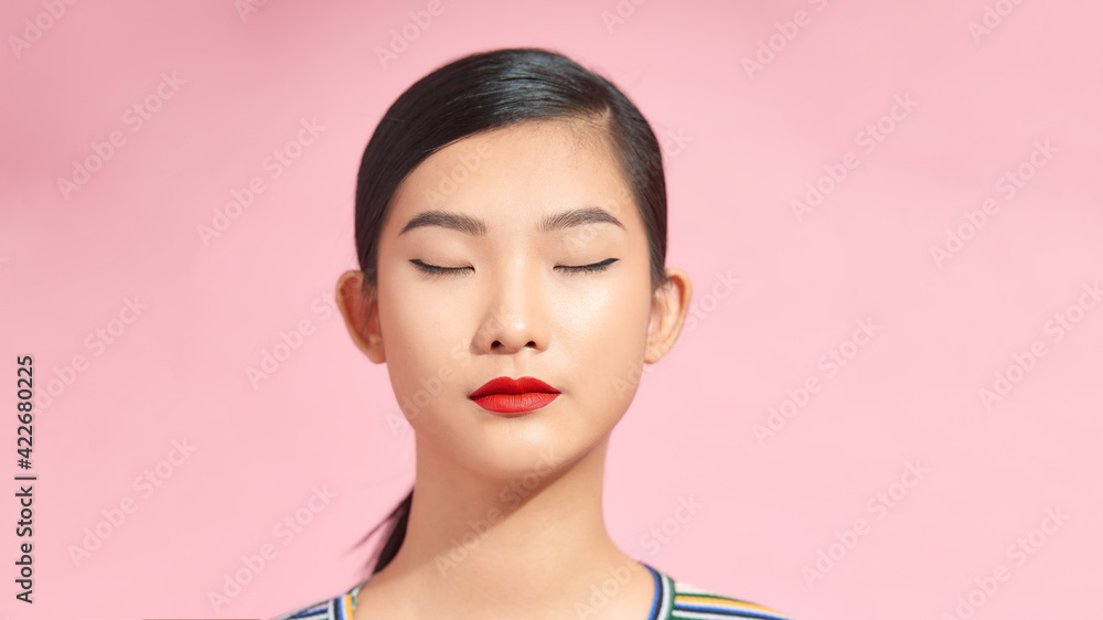 Beautiful female face close up portrait isolated. Eyes closed, beige eyeshadow makeup and red lips Beautiful female face close up portrait isolated. Eyes closed, beige eyeshadow makeup and red lips