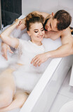 Lovers enjoying time together. Young passionate couple hugging.Beautiful couple kissing in bathtub. Intimate couple is spending nice time. The loving pleasures of a married couple in the bathroom.
