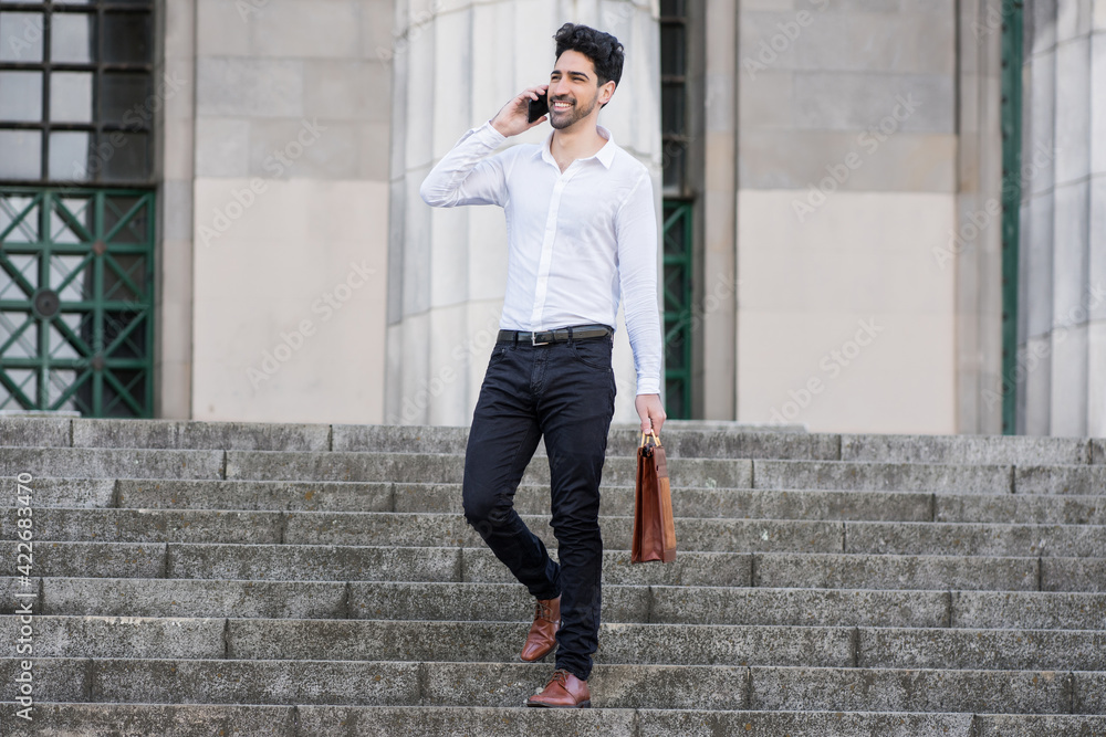 Businessman talking on the phone outdoors. Businessman talking on the phone outdoors.