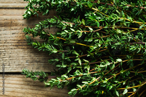 Freshly harvested bunch of thyme on the rustic background. Selective focus. Shallow depth of field.