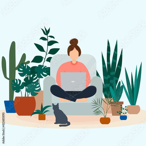 A girl with a laptop sits in a chair surrounded by plants growing in pots. Work at home and freelance concept.