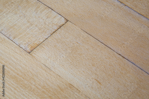 old parquet or laminate flooring deformed by water exposure. water exposure, wet coating close-up