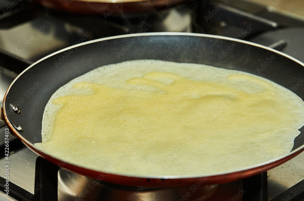 Pancakes are fried in pans on a gas oven. Step by step recipe.