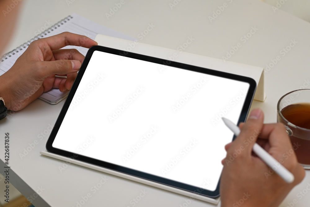 Close up vie of man holding digital tablet with blank screen and stylus pen. Close up vie of man holding digital tablet with blank screen and stylus pen.