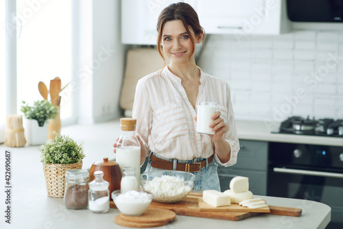 Young woman with milk at home in the kitchen. High quality photo.