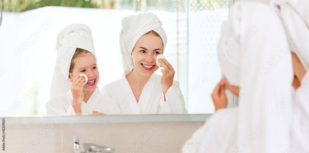 Mother and daughter doing face skin care Mother and daughter doing face skin care