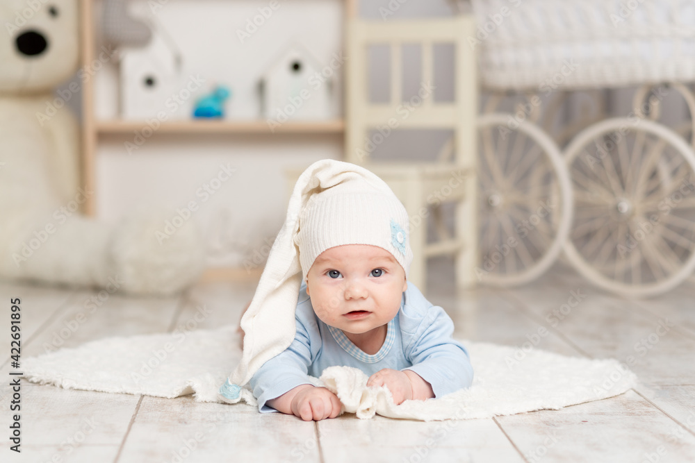 baby lies at home in the children's room with toys, development concept and games baby lies at home in the children's room with toys, development concept and games