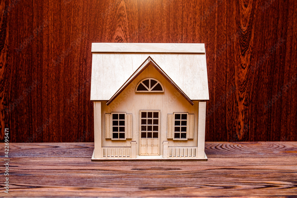 House symbol on a brown wooden background
House symbol on a brown wooden background