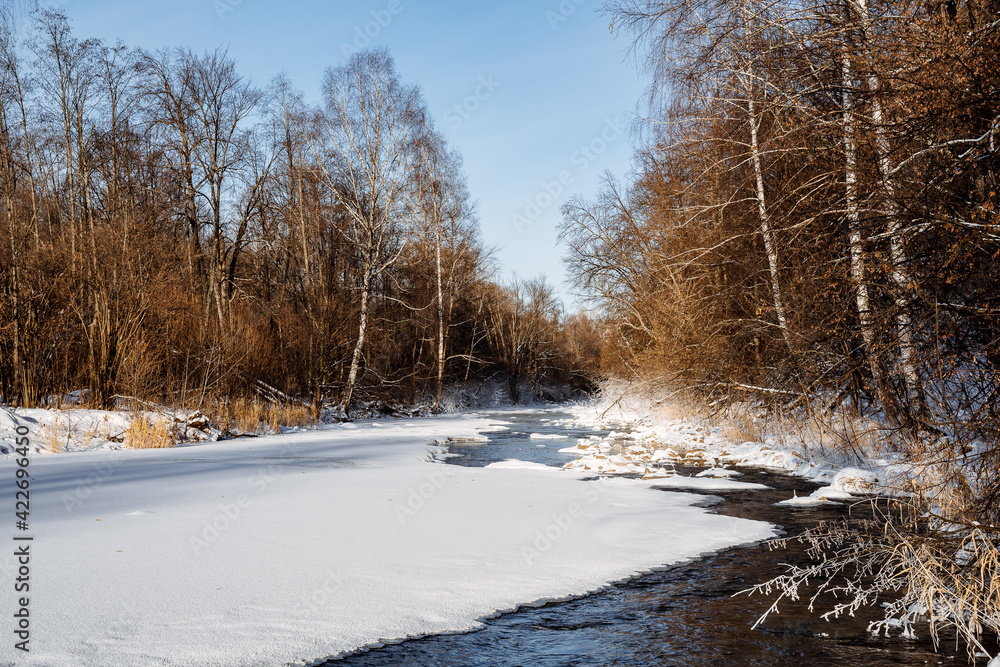 Open water snow frost. ice on the river froze. cold season. mountain stream stones. Thaw spring forest. nature silence Open water snow frost. ice on the river froze. cold season. mountain stream stones. Thaw spring forest. nature silence