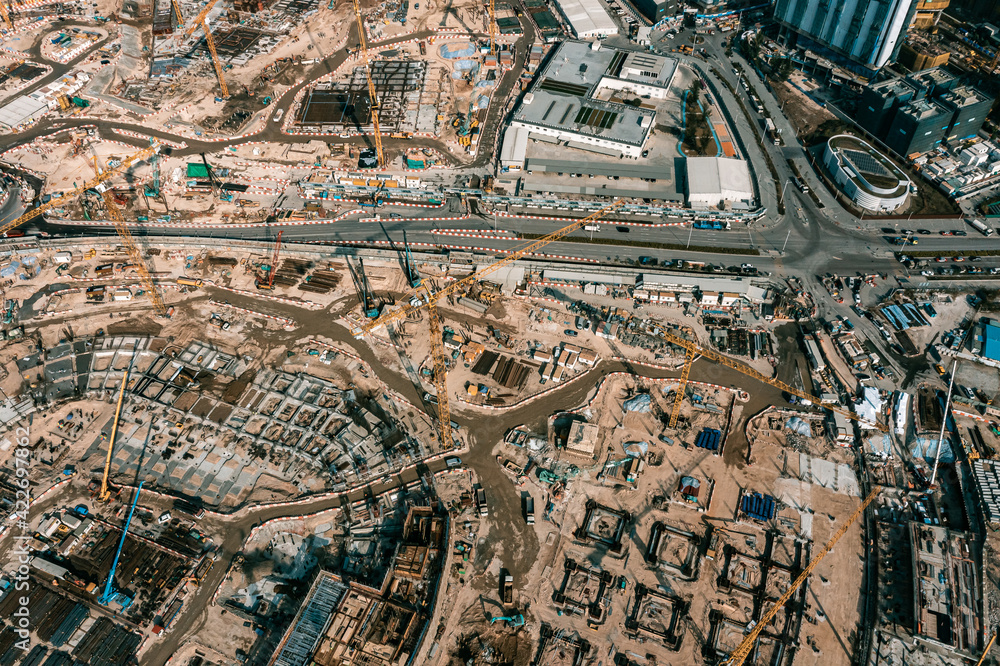 Top view at large construction sites and many cranes are working in the, Industry new building business. Top view at large construction sites and many cranes are working in the, Industry new building business.