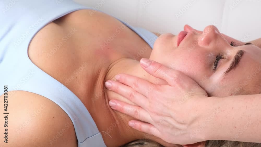 Chin massage of woman young woman during face massage at beauty salon Chin massage of woman young woman during face massage at beauty salon