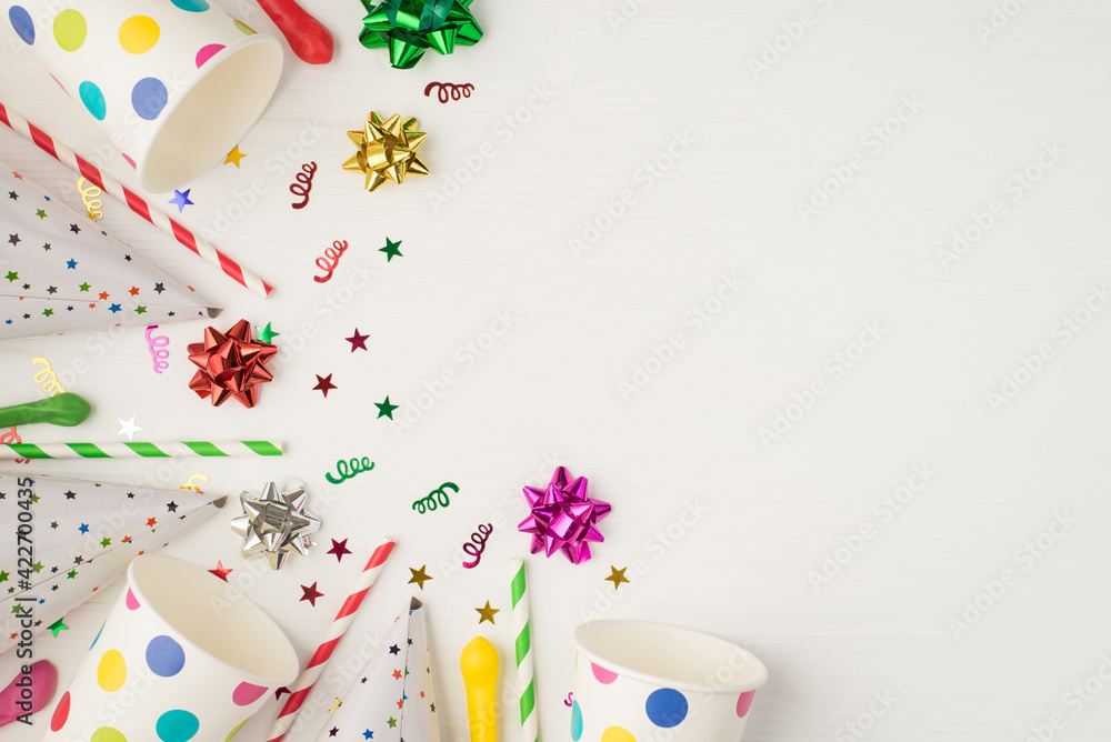 Above photo of cups confetti party tubules and birthday hat isolated on the white background with empty space