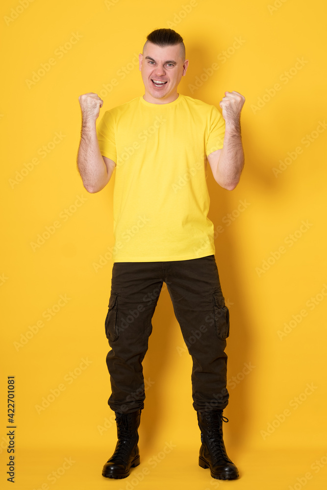 Young handsome man very happy and excited doing winner gesture with arms raised, smiling and screaming for success. Celebration. Young handsome man very happy and excited doing winner gesture with arms raised, smiling and screaming for success. Celebration.