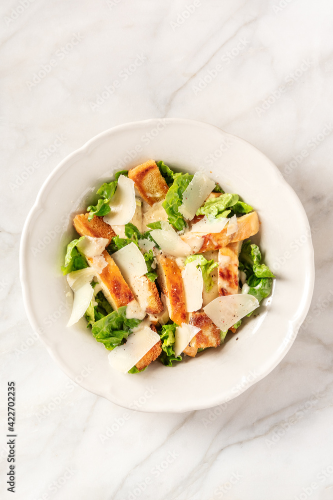 Caesar salad with grilled chicken, romaine and Parmesan cheese Caesar salad with grilled chicken, romaine and Parmesan cheese