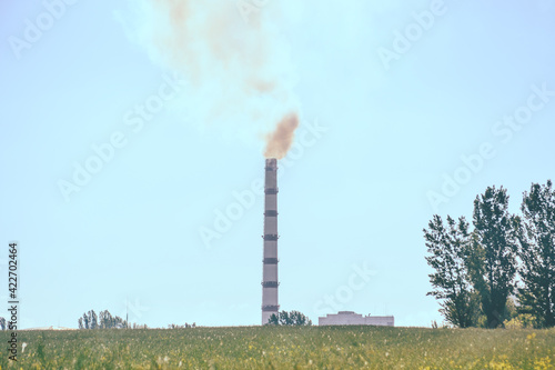 Pipe factory smoke in the field with clear sky