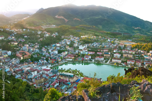 Beautiful view of Sapa town with pond and houses from viewpoint at sunset, Northern Vietnam