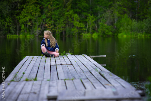blonde girl portrait outdoor, pond shore in summer, selective focus © Ekaterina
