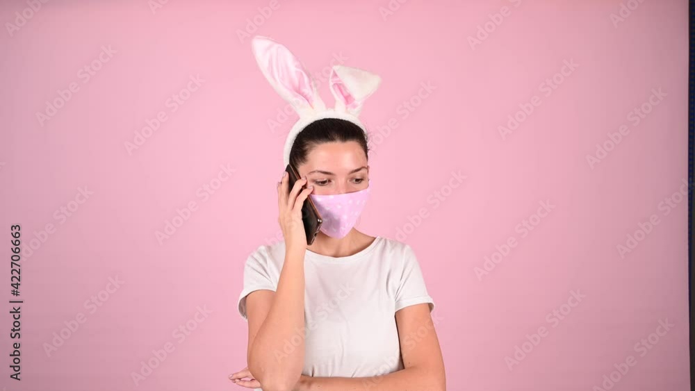 Girl with ears in a mask talking on the phone. High quality video Girl with ears in a mask talking on the phone. High quality video
