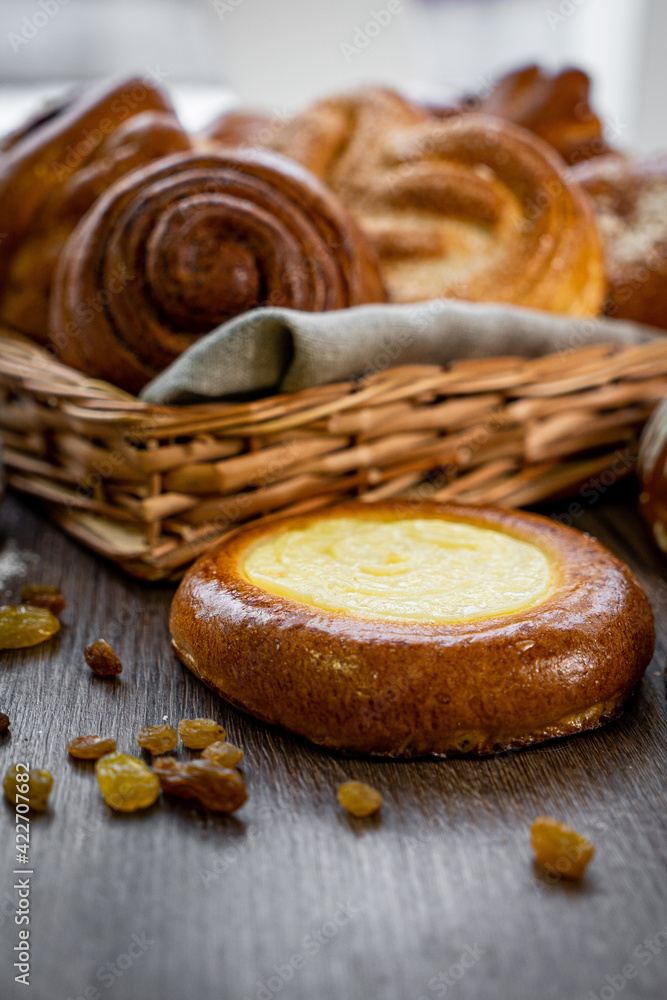 Basket of freshly baked dinner rolls with tableware in wooden background. Macro with shallow dof. Basket of freshly baked dinner rolls with tableware in wooden background. Macro with shallow dof.