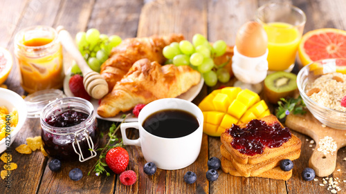 continental breakfast- coffee cup, croissant, cereal and fruit