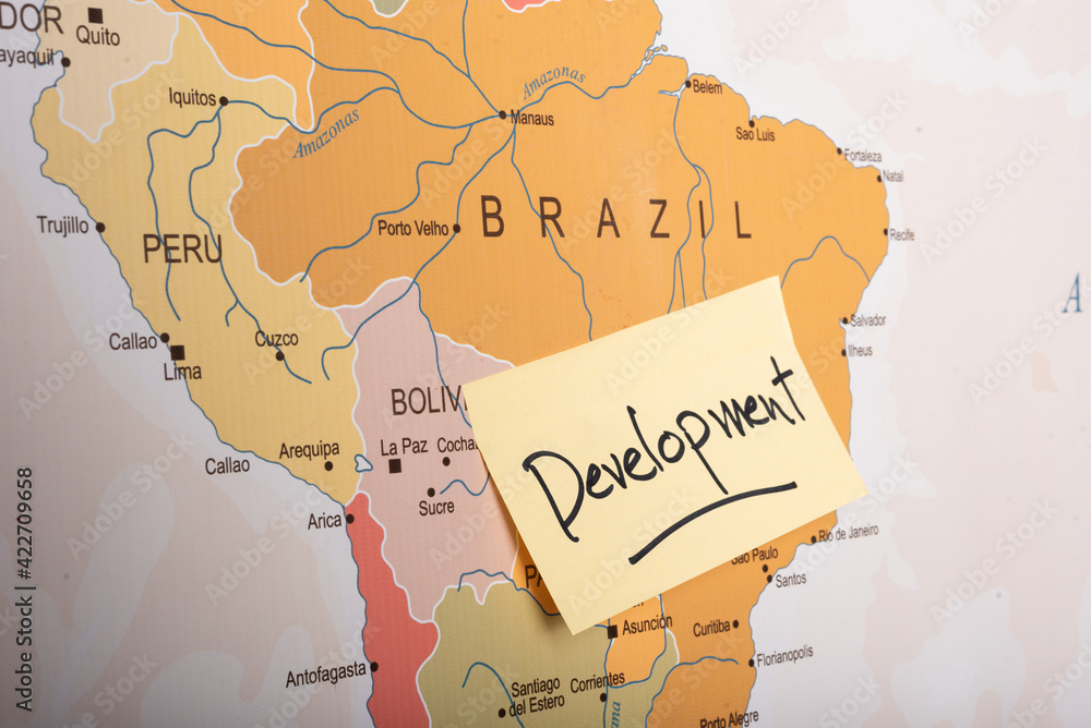 Obraz premium Development written on a sticky note attached with the Brazil country on world map.