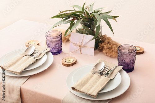 Beautiful table setting on color background photo