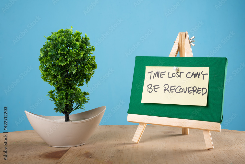 Time lost can not be recovered written on a sticky note on a mini green