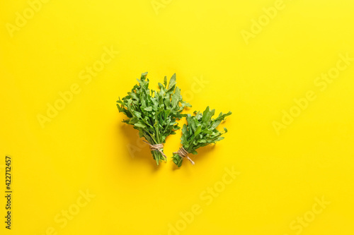 Bunches of fresh arugula on color background © Pixel-Shot