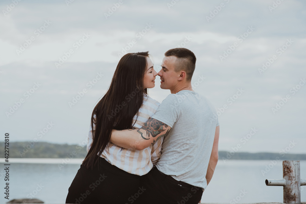 Young Caucasian happy couple hug and smile on the beach Young Caucasian happy couple hug and smile on the beach