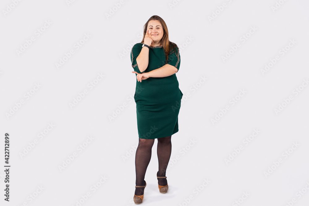 Full length photo of attractive plump woman smiling and posing happily against gray background. Lifestyle of overweight people. Full length photo of attractive plump woman smiling and posing happily against gray background. Lifestyle of overweight people.