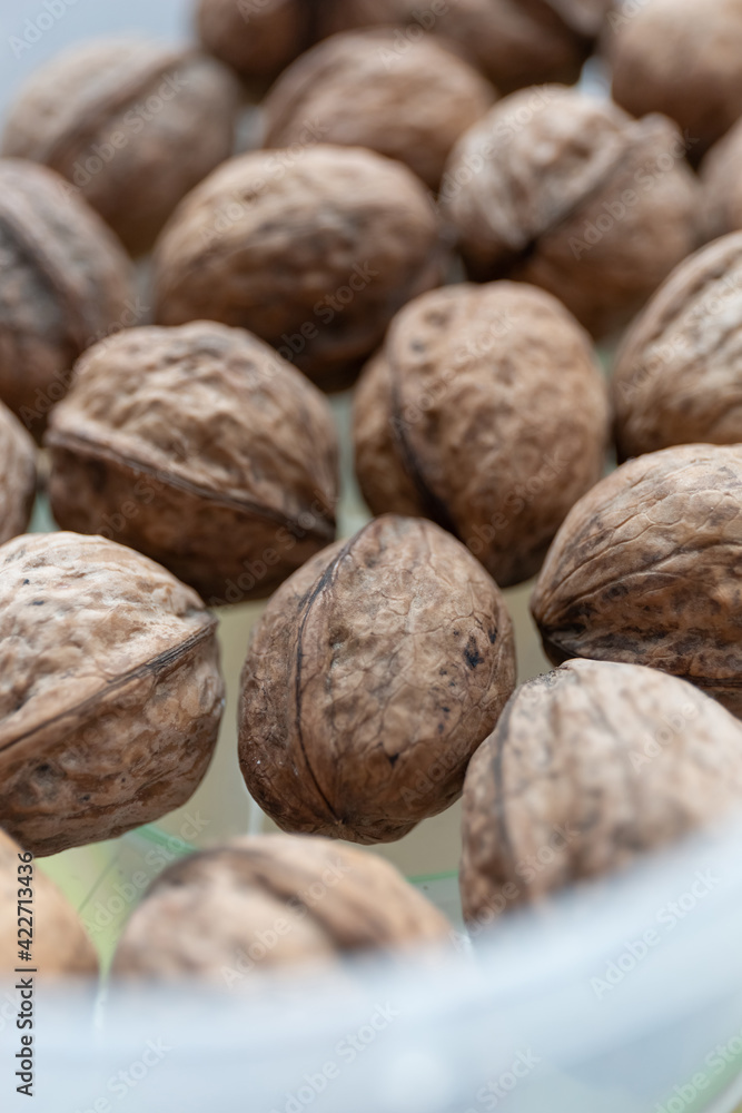 Close up of walnuts on a kitchen table in a container Close up of walnuts on a kitchen table in a container