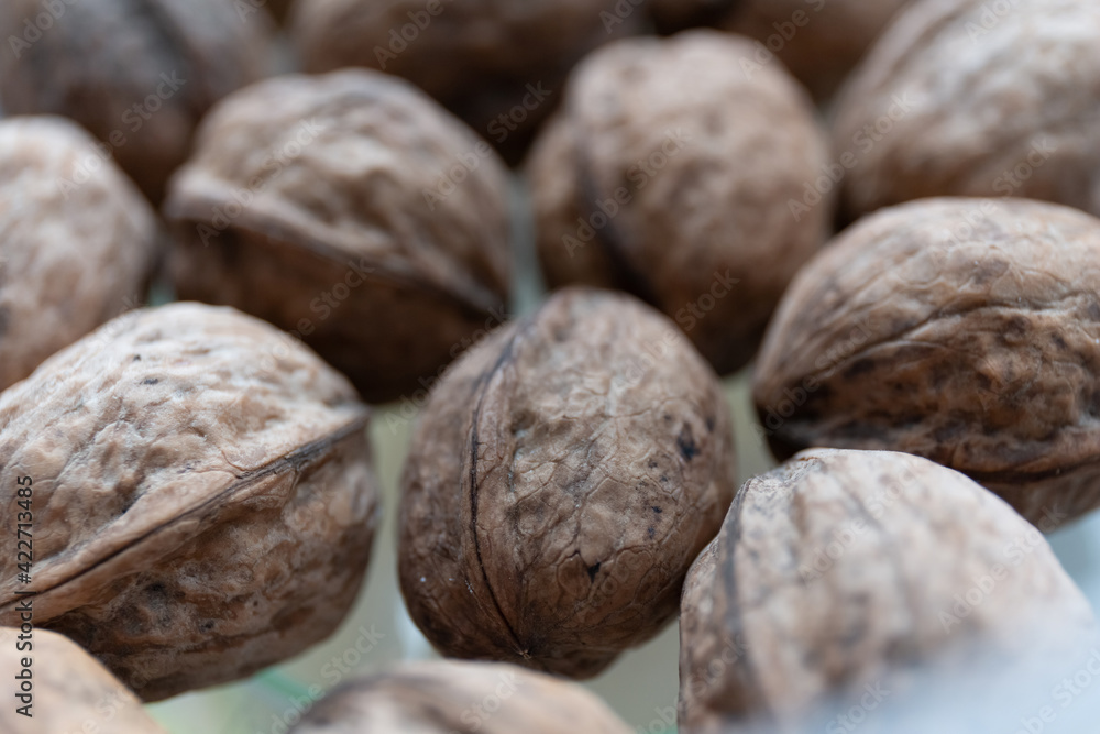 Close up of walnuts on a kitchen table in a container Close up of walnuts on a kitchen table in a container