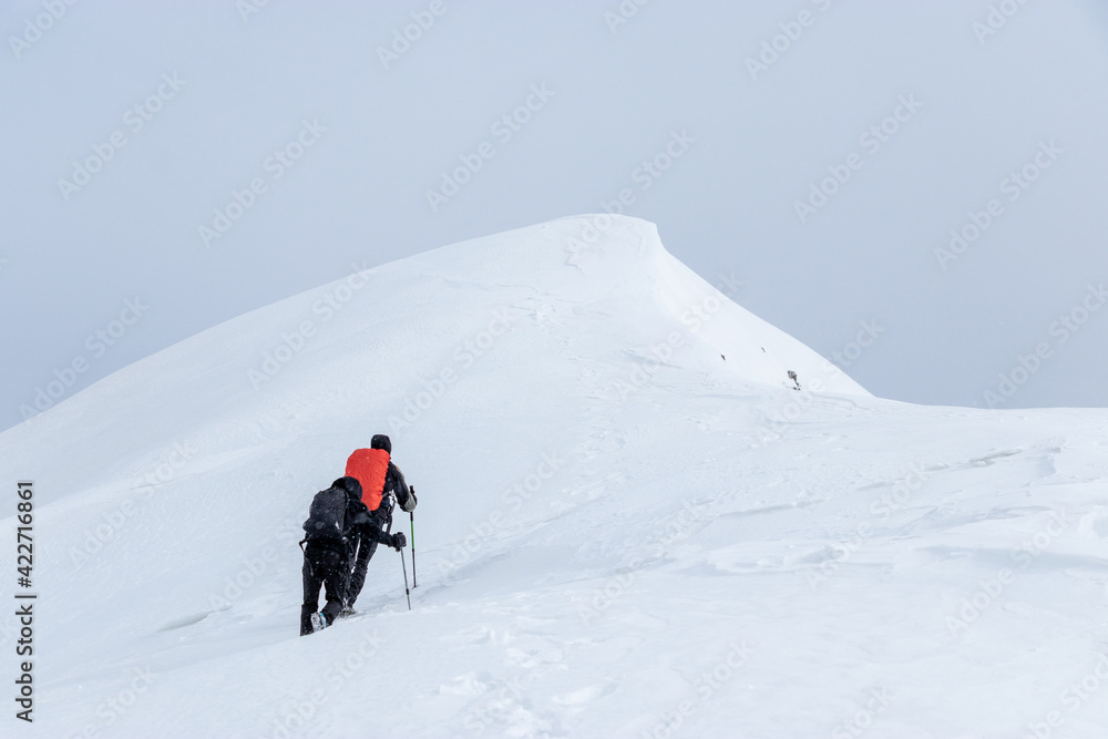 Two mountaineers on the way to the summit of mountain Velika Baba (2148m) which lies on the border between Slovenia and Italy.