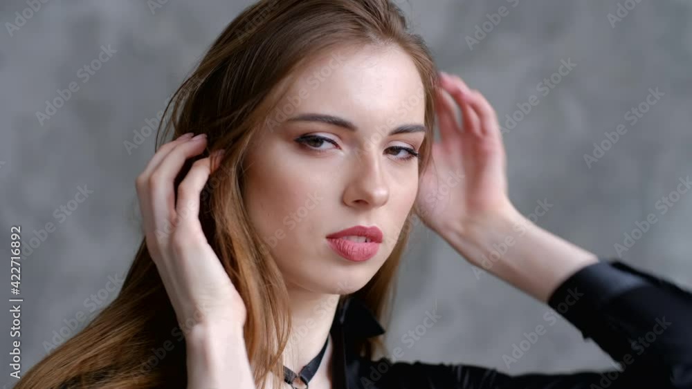 Closeup shot of beautiful young woman playing with her long hair Closeup shot of beautiful young woman playing with her long hair
