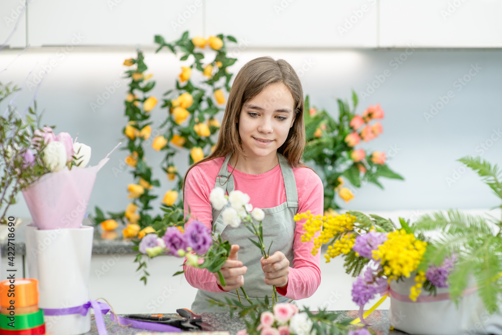 Happy teen girl arranging flower at flower shop. Hobby and leisure concept Happy teen girl arranging flower at flower shop. Hobby and leisure concept