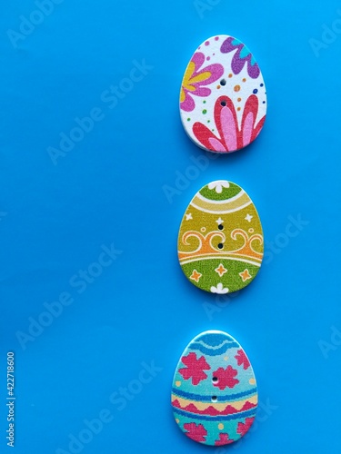 wooden buttons in the shape of an egg on a blue background