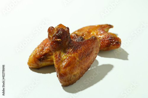 Baked chicken wings on white background, close up