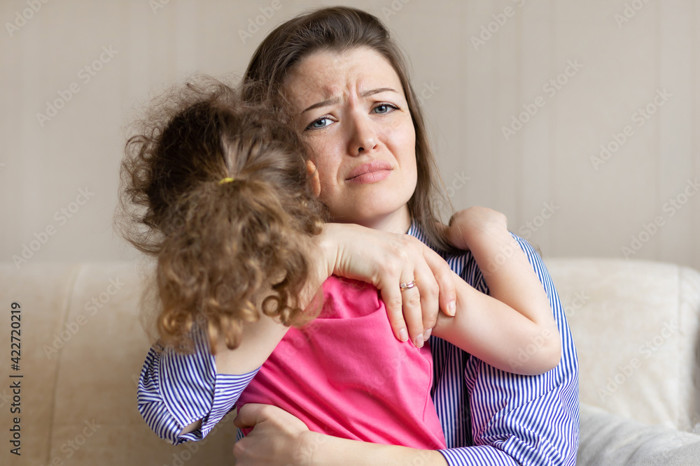 worried loving mother hug, tightly hold crying baby sitting in her hands. young woman pity upset girl. reconciliation with parents. warm relations in the family, childhood, motherhood, parenthood worried loving mother hug, tightly hold crying baby sitting in her hands. young woman pity upset girl. reconciliation with parents. warm relations in the family, childhood, motherhood, parenthood