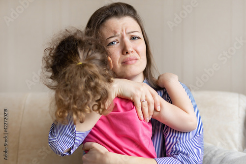 Obraz na plátně worried loving mother hug, tightly hold crying baby sitting in her hands