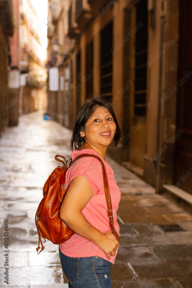 Girl with backpack and pink T-shirt by Borne in Barcelona, lifestyle concept