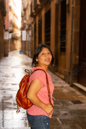 Girl with backpack and pink T-shirt by Borne in Barcelona, lifestyle concept