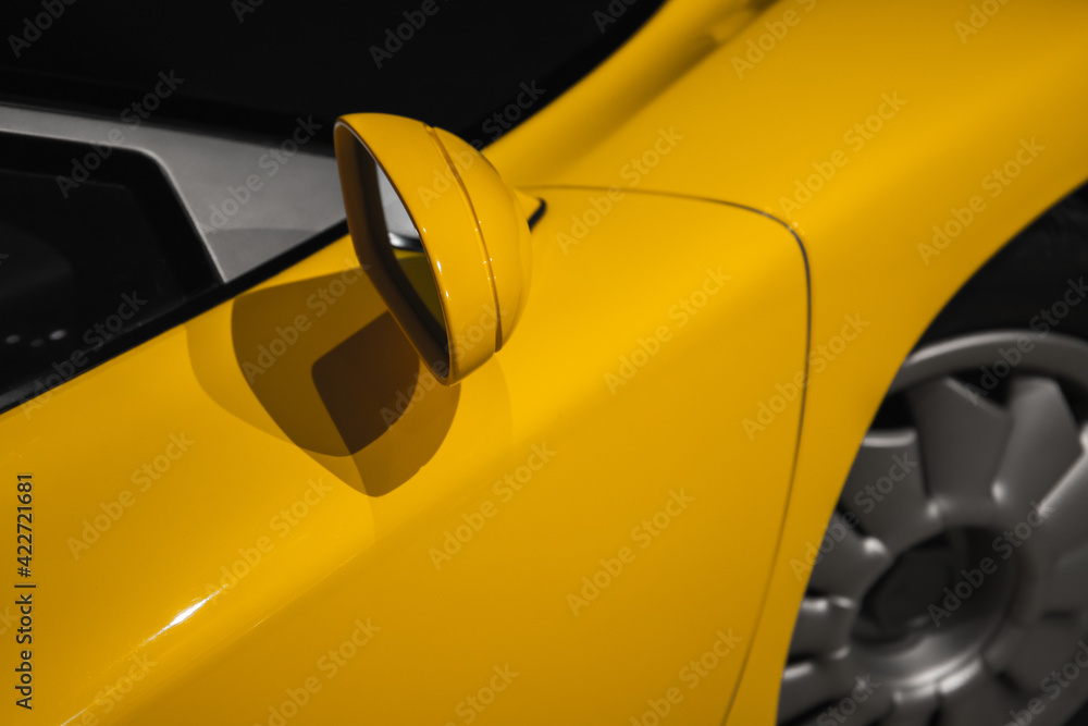 Yellow sports car mirror, close up photo