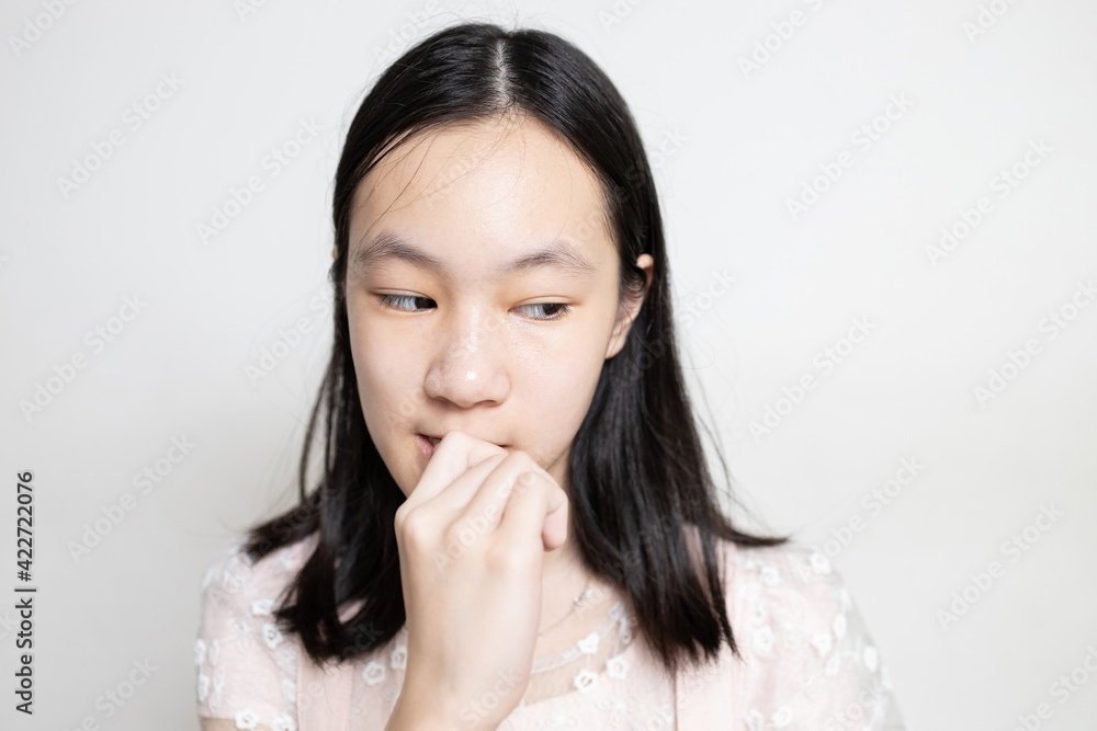 Stressed asian lady girl bites finger nails,thinking about something,anxious problems,scared,anxious with hand on mouth biting her nails,worried student with nervous expression,mental health concept. Stressed asian lady girl bites finger nails,thinking about something,anxious problems,scared,anxious with hand on mouth biting her nails,worried student with nervous expression,mental health concept.