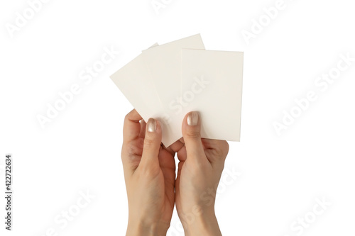 Hands of young woman with golden nail polish holding three blank business cards mockup, stationery template isolated on white background.
