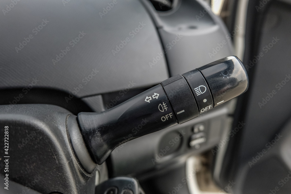 Switch off lights in a car. close-up Car integrated turning indicator with headlight switch toggle.