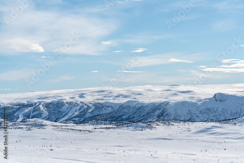 Spectacular view over snow covered valleys and mountains during winter.