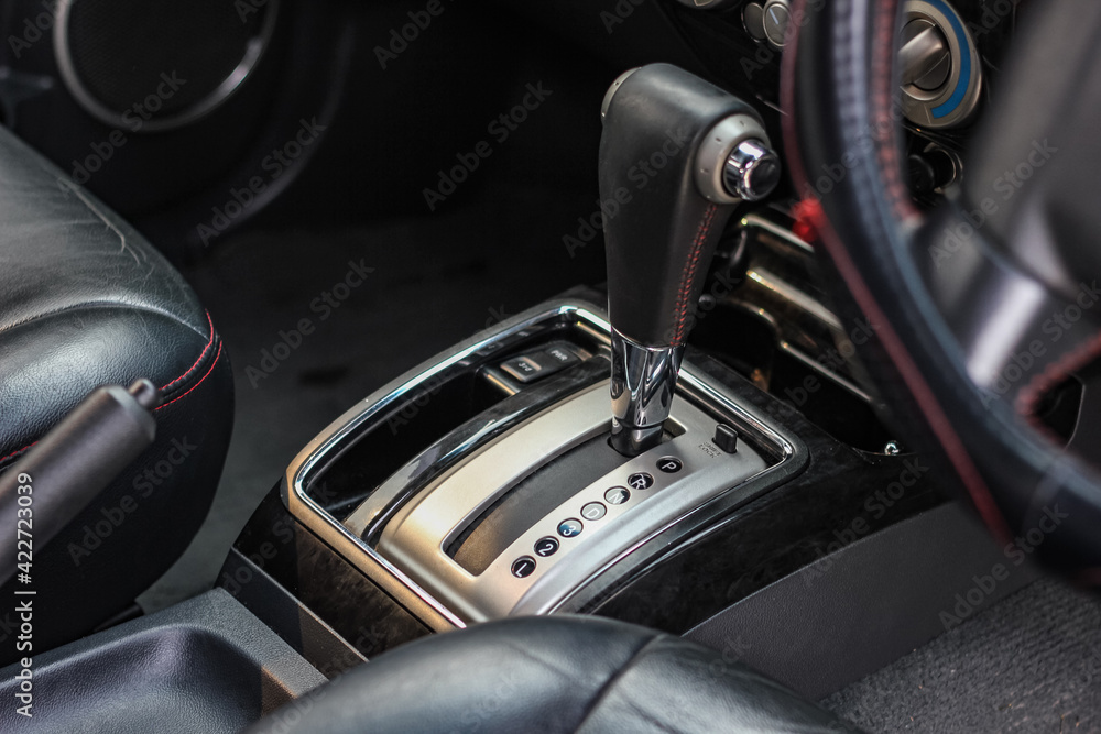 automatic transmission shift selector in the car interior. Closeup a manual shift of modern car gear shifter. automatic transmission shift selector in the car interior. Closeup a manual shift of modern car gear shifter.