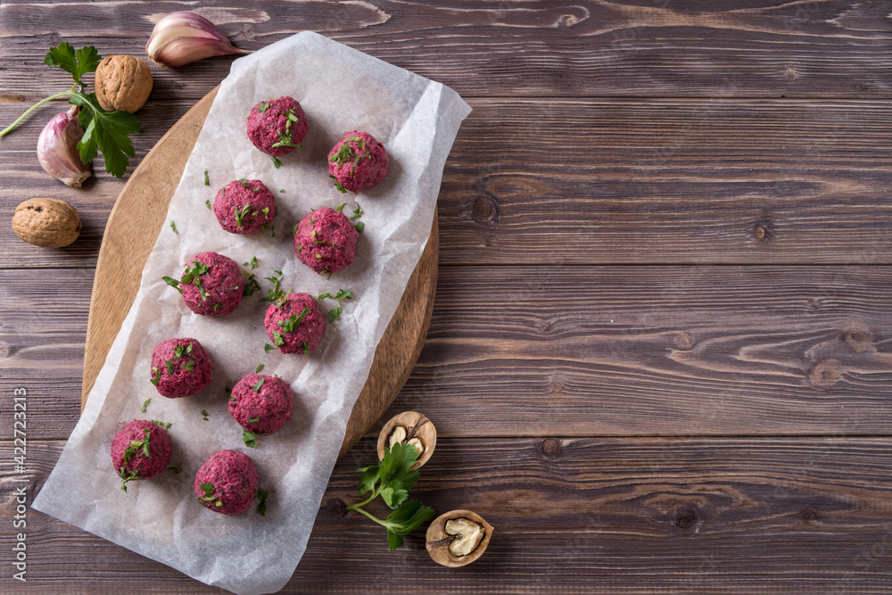 Georgian beetroot phali or pkhali with walnuts, garlic and spices on wooden background. Georgian beetroot phali or pkhali with walnuts, garlic and spices on wooden background.