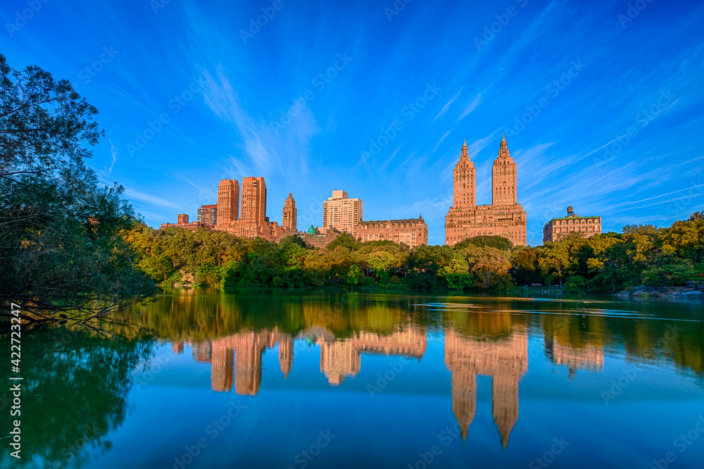 Skyline with apartment skyscrapers over lake in Central Park in midtown Manhattan in New York City