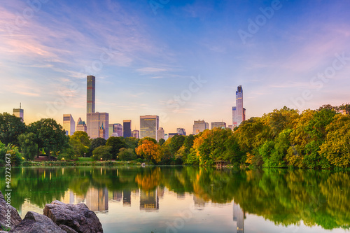 Cityscape of Central Park south from the lagoon in Central Park, New York, New York, USA.